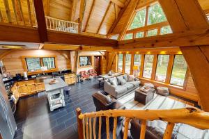 an overhead view of a living room in a log cabin at The Cabin on 32 wooded acres - tranquil new-build with sauna & forested views in Franklin