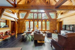 a large living room with wooden ceilings and windows at The Cabin on 32 wooded acres - tranquil new-build with sauna & forested views in Franklin