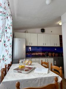 a kitchen with a table with wine glasses on it at Studio Apartments Ivo in Baška Voda