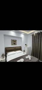 a bedroom with a bed with two towels on it at Aggelos Room 4 in Volos