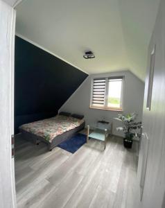 a small bedroom with a bed and a window at Wakacyjne relaksacyjnie in Szczytno