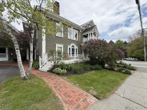a house with a brick walkway in front of it at Commanders Cabin, quaint apt steps to downtown in Camden