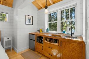 a kitchen with a wooden counter and a sink at Lindquist Cottage | Waterfront Studio with King Bed in Clark Island