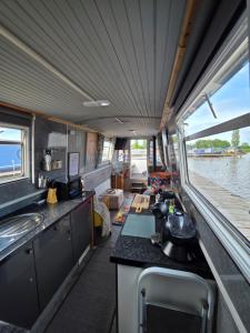 an inside view of a kitchen in a boat at Komet Canal Boats in Nantwich