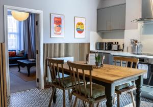 a kitchen and dining room with a wooden table and chairs at Spacious One-Bed Apartment in Chester in Chester