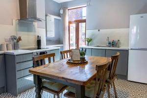 a kitchen with a wooden table and some chairs at Spacious One-Bed Apartment in Chester in Chester