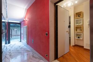 a hallway with a red wall and a glass door at Ca' Dei Bolzeri in Venice +12 photos