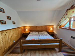 a bedroom with a bed and two night stands at Chalupa pod Skleným Vŕškom in Huty +16 photos