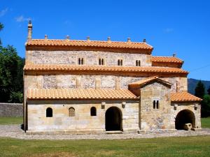 a large stone building with a red roof at Ayalga2 in Villaviciosa