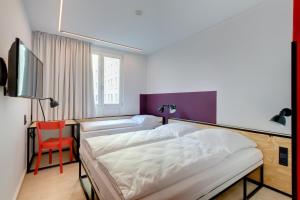 Postel nebo postele na pokoji v ubytování MEININGER Hotel Leipzig Hauptbahnhof + 37 fotografií