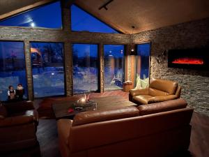 a living room with a couch and a fireplace at Trudvang in Tänndalen
