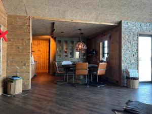 a kitchen with a table and chairs in a room at Trudvang in Tänndalen
