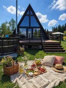 a picnic table with fruits and vegetables in front of a church at Cabana Golden Sunset in Mărişel