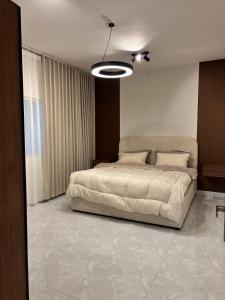 a bedroom with a large bed in a room at Olive home in Al Khobar