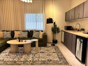 a living room with a couch and a table at Olive home in Al Khobar