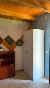 a white cabinet in a room with a wooden ceiling at Balabani Local Stay in Podgorica