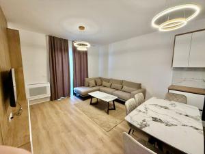 a living room with a couch and a table at Golden Space Apartment 3 in Tirana