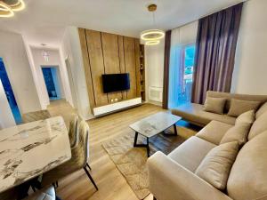 a living room with a couch and a table at Golden Space Apartment 3 in Tirana