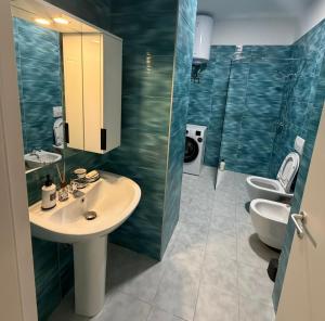a bathroom with a sink and two toilets in it at Golden Space Apartment 3 in Tirana +46 photos