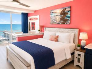 a bedroom with a bed with a view of the ocean at Updated Oceanfront Suite by Skywheel Yachtsman 902 in Myrtle Beach