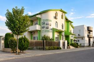 a green and white building on the side of a street at Villa Jovan Gevgelija in Gevgelija