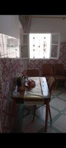 a living room with a table and a couch at Maison Bab boujloud in Fez