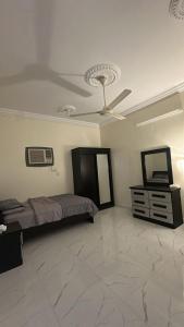 a bedroom with a bed and a ceiling fan at رابغ in Rabigh