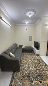 a living room with a couch and a rug at رابغ in Rabigh