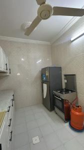 a kitchen with a stove and a ceiling fan at رابغ in Rabigh