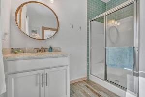 a bathroom with a shower and a sink and a mirror at Ocean Breeze West Wind – Updated 2BR/2BA home step in Owls Head +14 photos