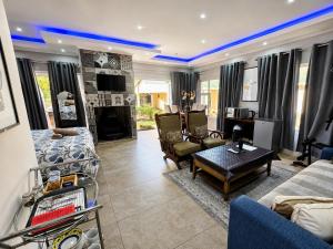 a living room with a couch and a table at Waterfall City Guest Lodge in Sandton