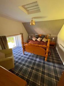 a bedroom with a bed and a couch at Apartment Sleeps 2 with WiFi in Wick +8 photos