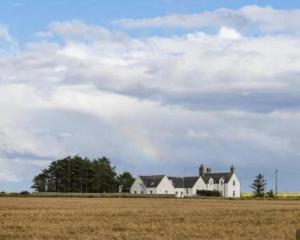 a large white house in the middle of a field at Apartment Sleeps 2 with WiFi in Wick