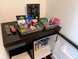 a small refrigerator with food and drinks on a counter at Hotel Embajada 44 in Bogotá