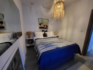 a bedroom with a bed and a chandelier at Garden in Šibenik
