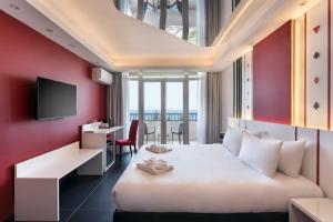 a hotel room with a bed and a desk at Vegas Resort in St. Julianʼs