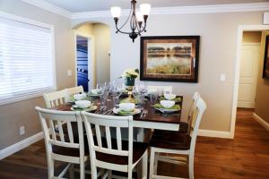 a dining room with a wooden table and chairs at Lavish 5 Bedroom, 4 Bath Pool Home 3/4 Mile To Disney in Anaheim