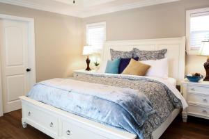 a bedroom with a white bed and two night stands at Lavish 5 Bedroom, 4 Bath Pool Home 3/4 Mile To Disney in Anaheim +19 photos