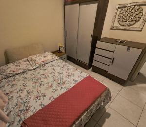 a bedroom with a bed and a dresser and a cabinet at Apartamento Mobiliado - Botafogo in Rio de Janeiro