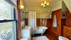a bathroom with a tub and a sink at Commanders Cabin, quaint apt steps to downtown in Camden +20 photos
