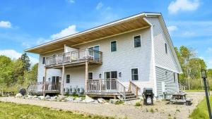 a large white house with balconies on it at Ocean Breeze West Wind – Updated 2BR/2BA home step in Owls Head