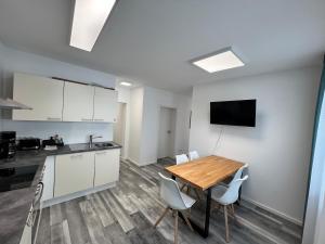 a kitchen and dining room with a table and chairs at Jagsttalglück in Neudenau +17 photos