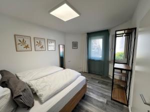 a bedroom with a bed and a ladder in it at Jagsttalglück in Neudenau