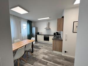 a kitchen with a table and chairs in a room at Jagsttalglück in Neudenau