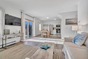 a living room with a couch and a starfish on the floor at Ocean Breeze West Wind – Updated 2BR/2BA home step in Owls Head