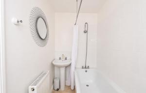 a white bathroom with a sink and a tub and a mirror at York House - Garston - 3 bedroom - Sleeps 6 in Liverpool