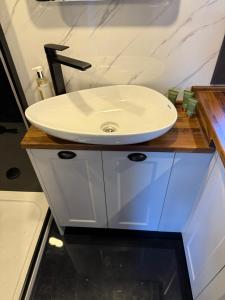 a bathroom with a white sink on a counter at Kniveton Wood Hut in Ashbourne +13 photos