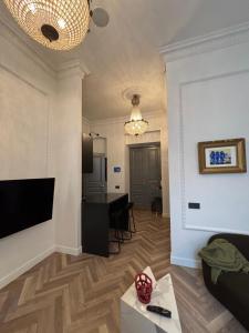 a living room with a couch and a dining room at The Gediminas Residence in Vilnius +5 photos