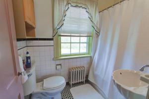 a bathroom with a toilet and a sink and a window at Welcome to your private cozy room #2 near LU, Stadium & general hospital in Lynchburg