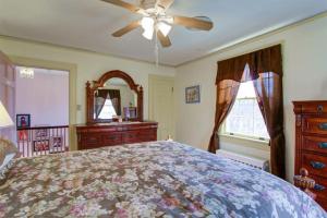 a bedroom with a bed and a ceiling fan at Welcome to your private cozy room #2 near LU, Stadium & general hospital in Lynchburg